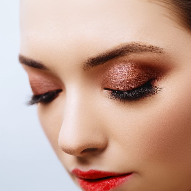 A woman applying crease colour (eyeshadow) 