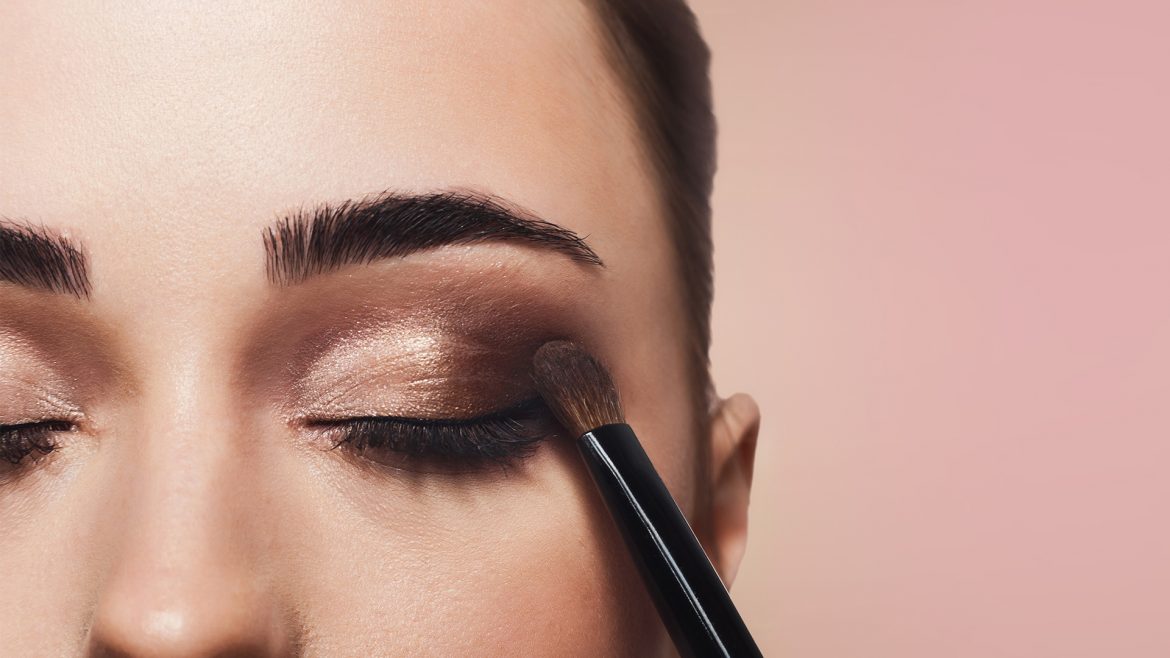 A woman applying eyeshadow