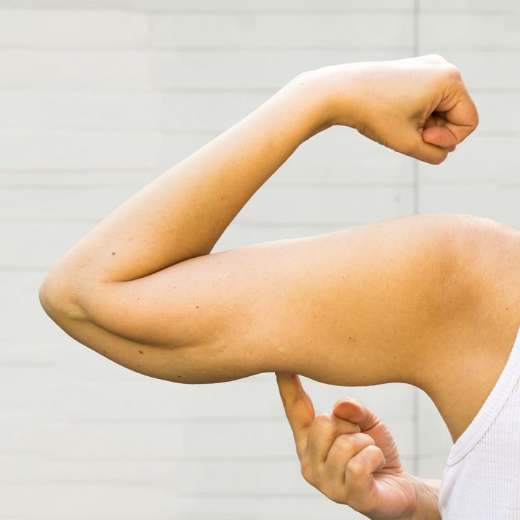 A healthy person flexing his muscles