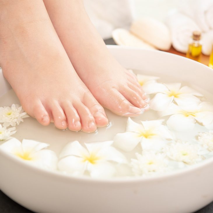 Woman soaking her feet in warm water