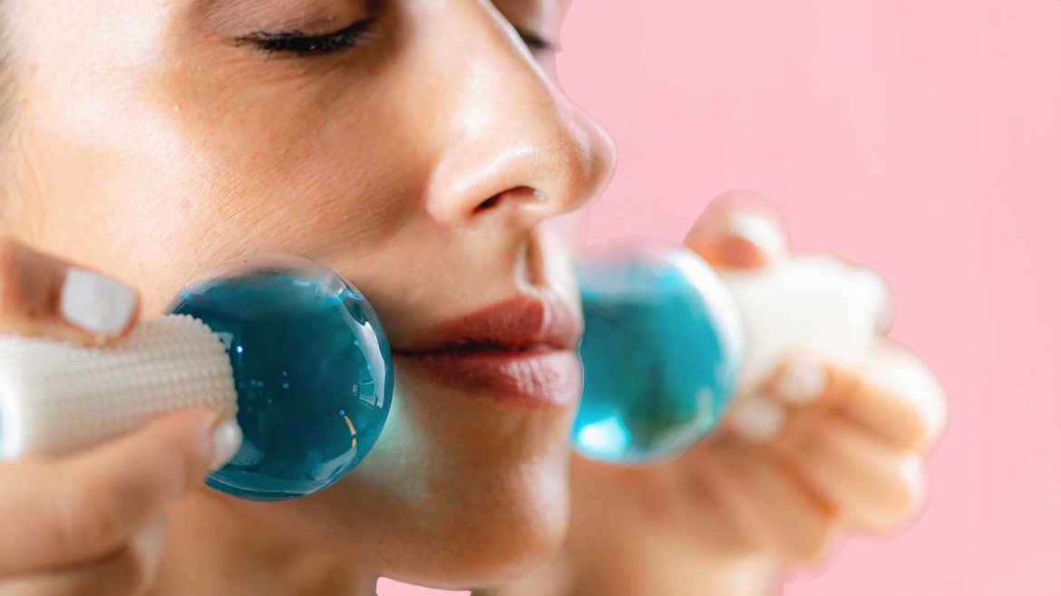 A woman using ice tools on her face