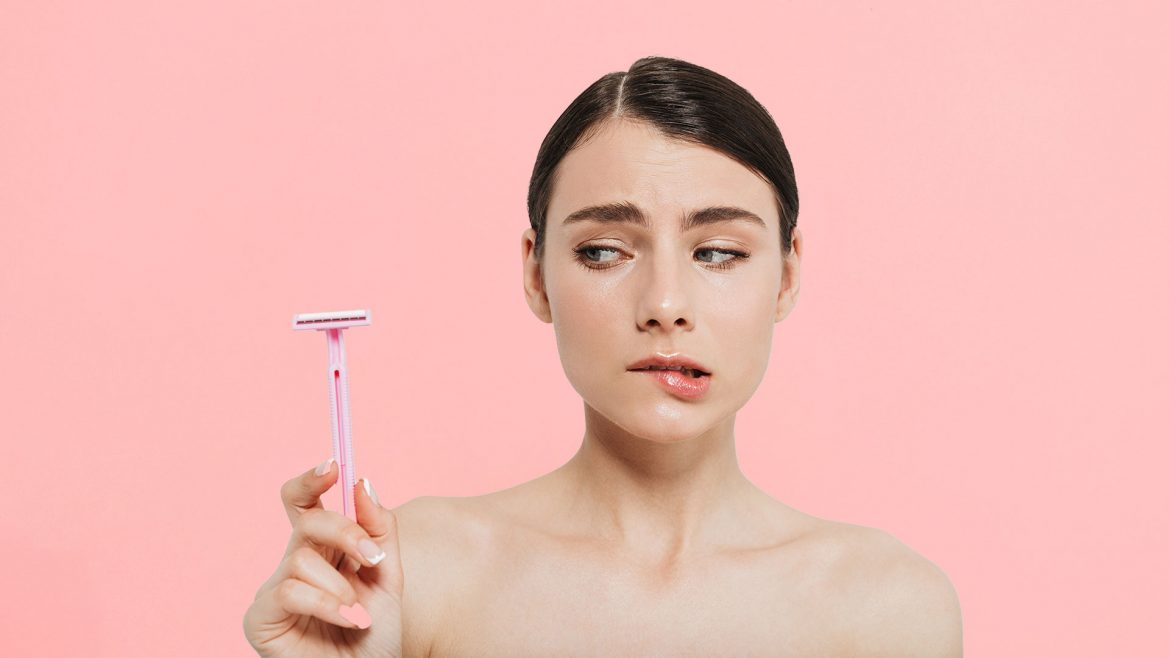 Woman with a face razor in her hand