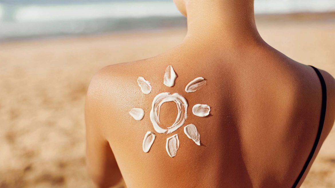 Woman with sunscreen on her back.