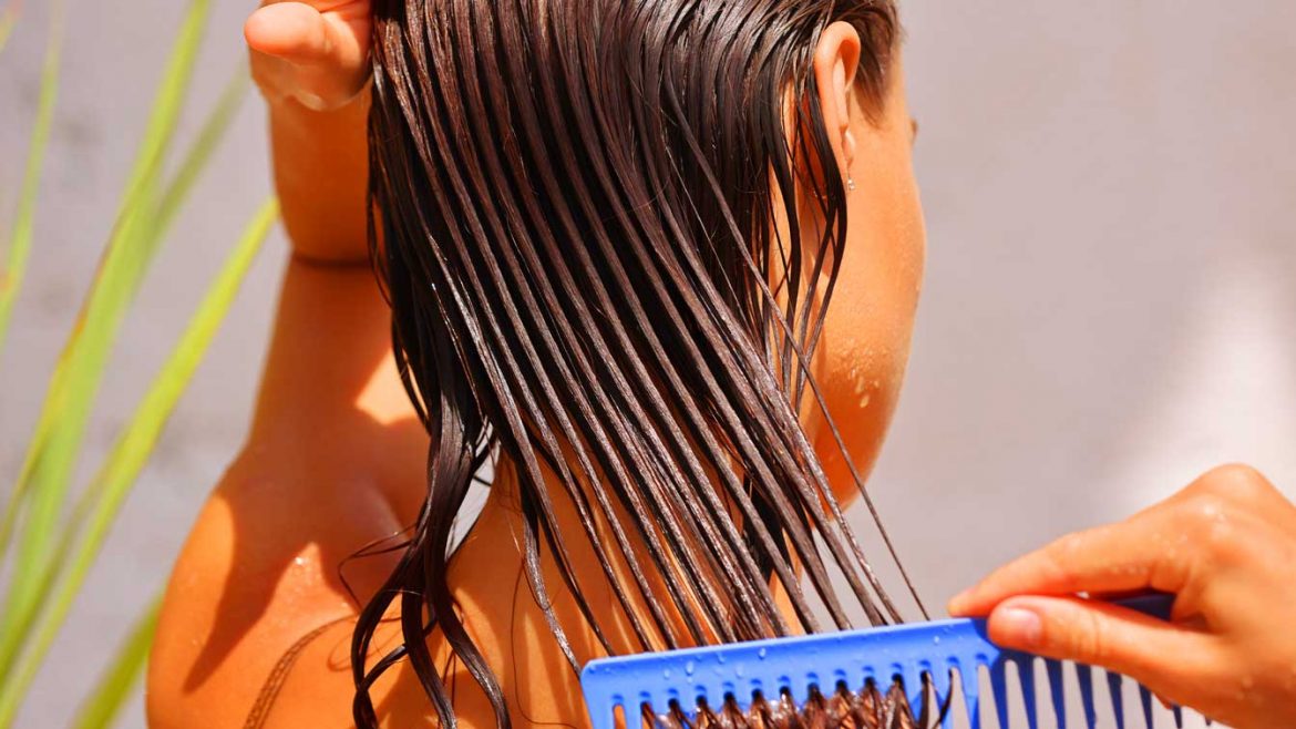 A woman brushing her hair after a hot oil massage