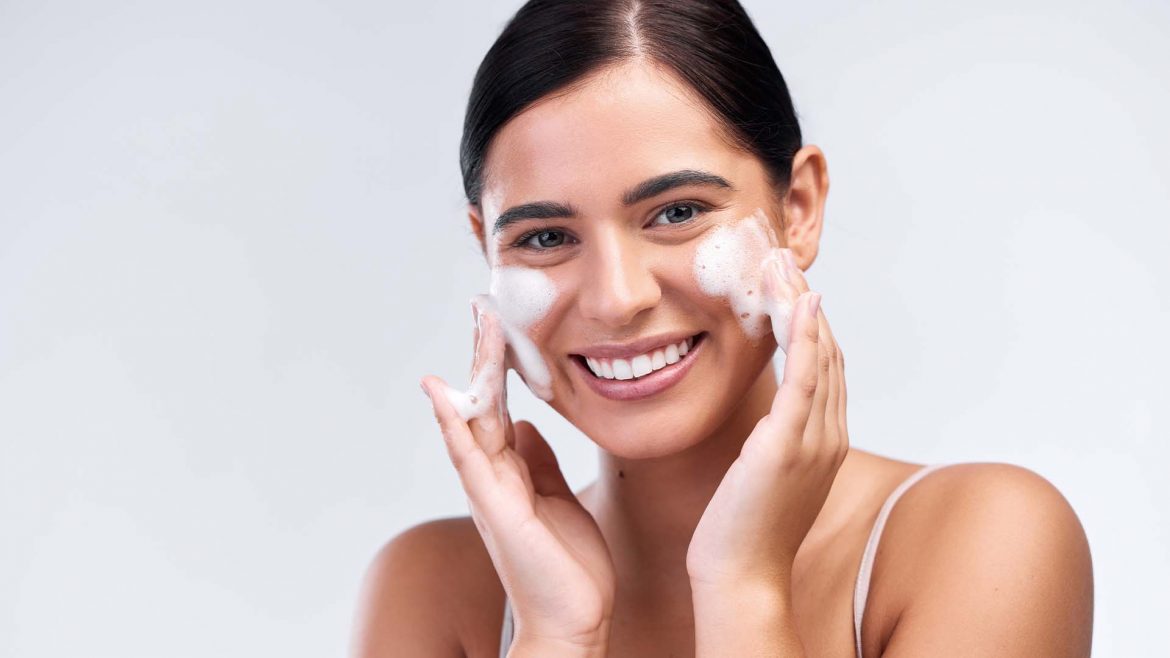 Woman cleansing her face