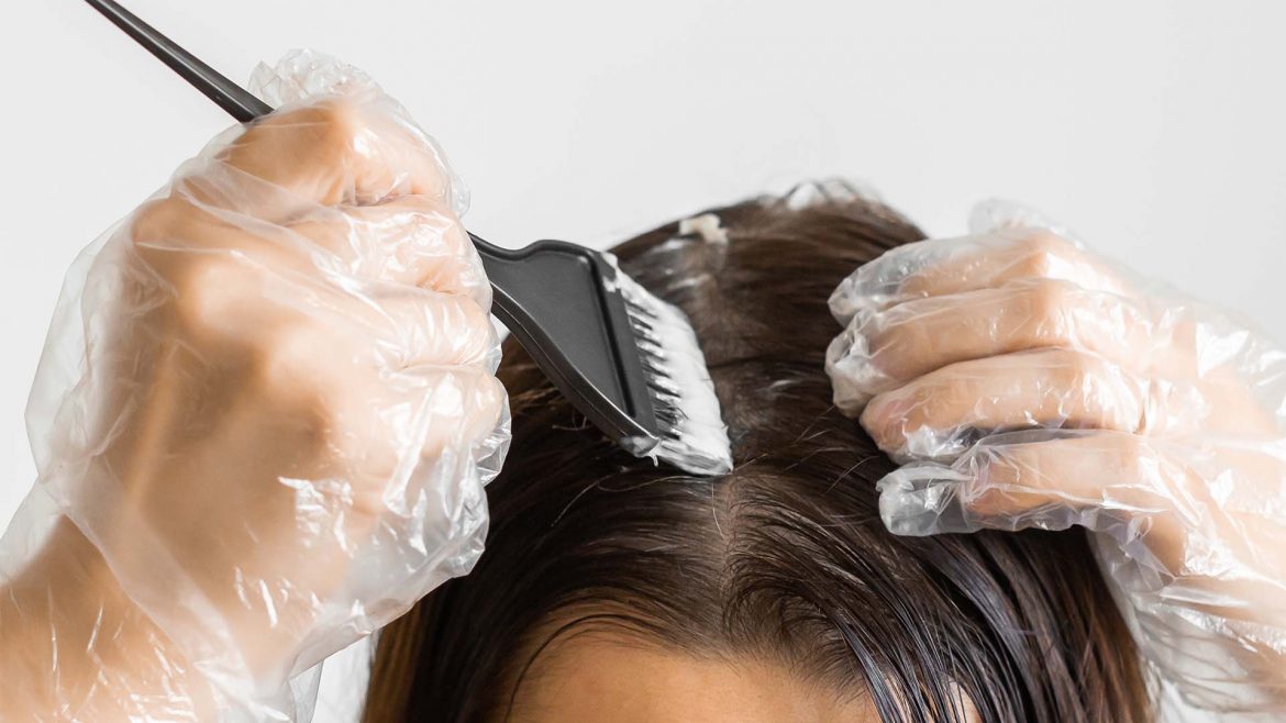 Woman applying colour to her hair