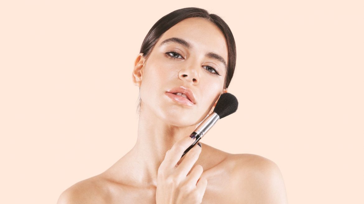 Woman holding a makeup brush