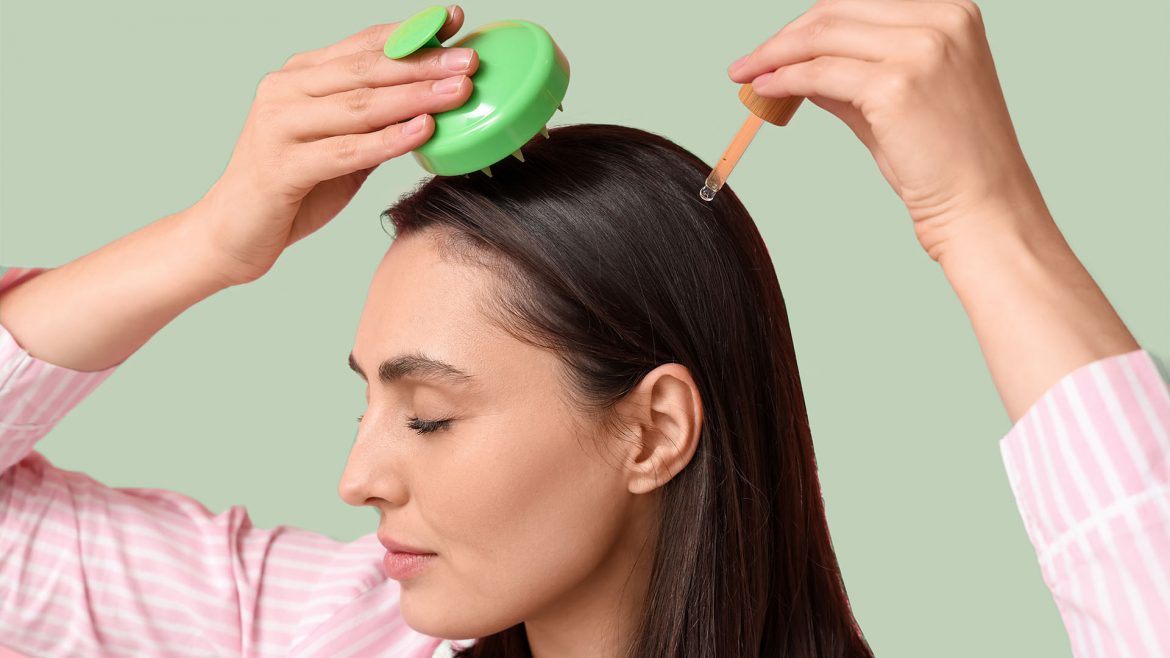 Woman massaging bhringraj oil into her scalp