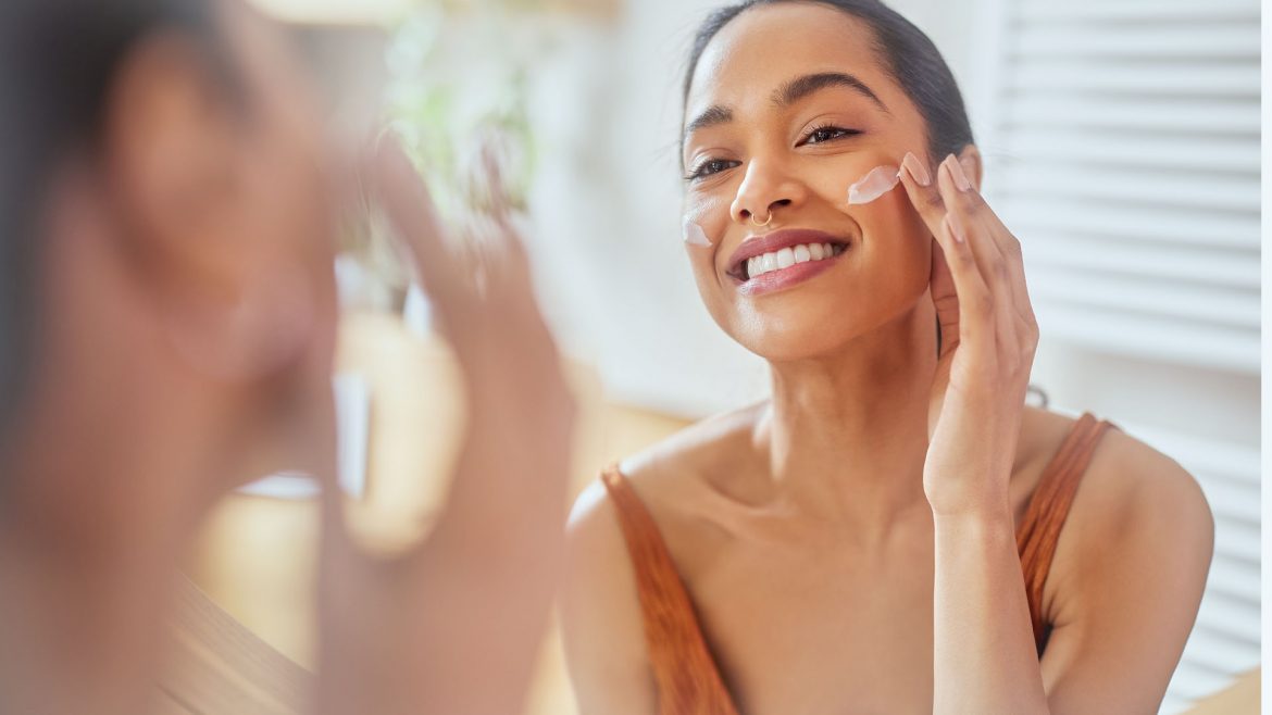 Woman applying active skincare during the day