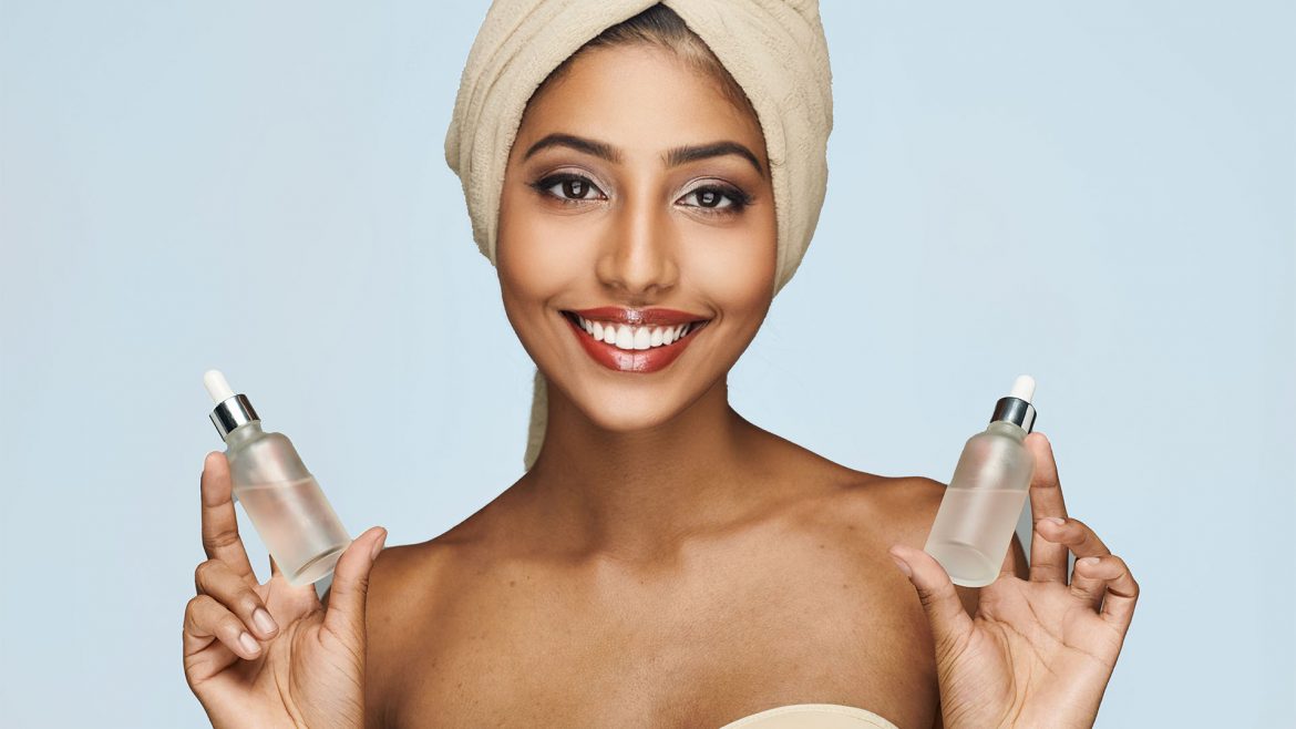 Woman holding active skincare products in her hand