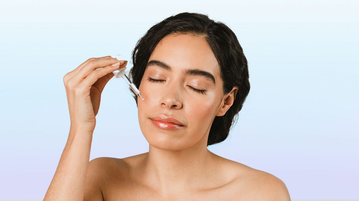 Woman applying glycerin on her face