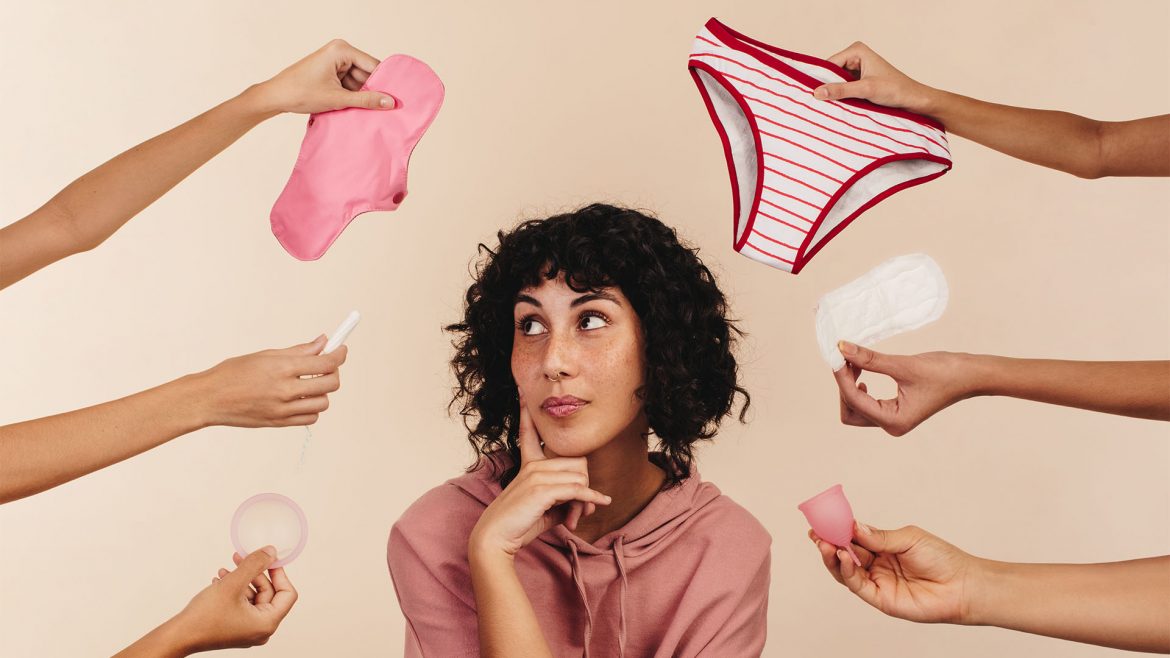 Image of a woman with pads, tampons & menstural cups being shown to her