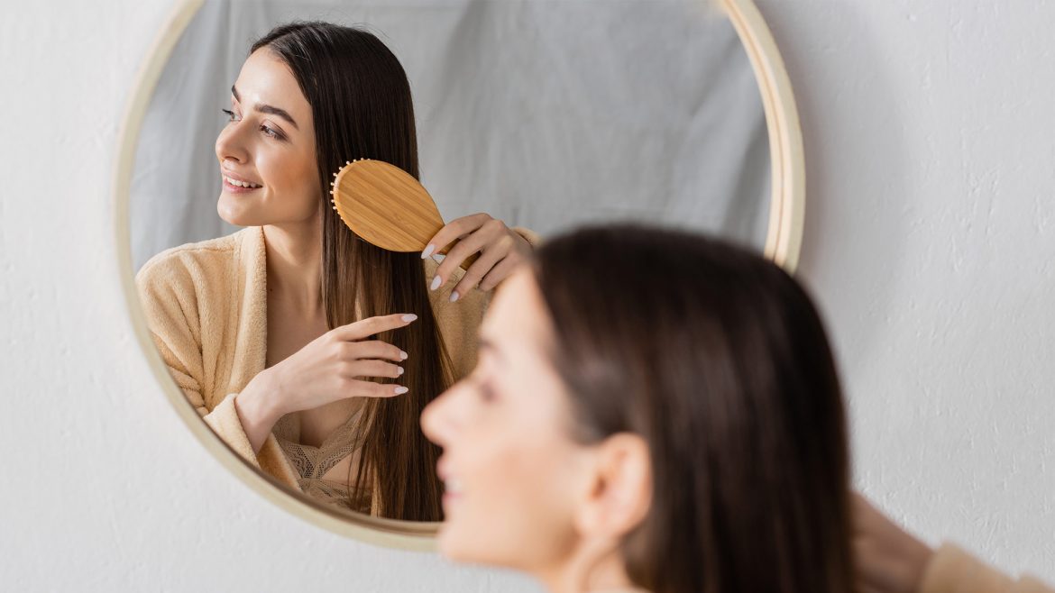 Woman gently brushing her hair