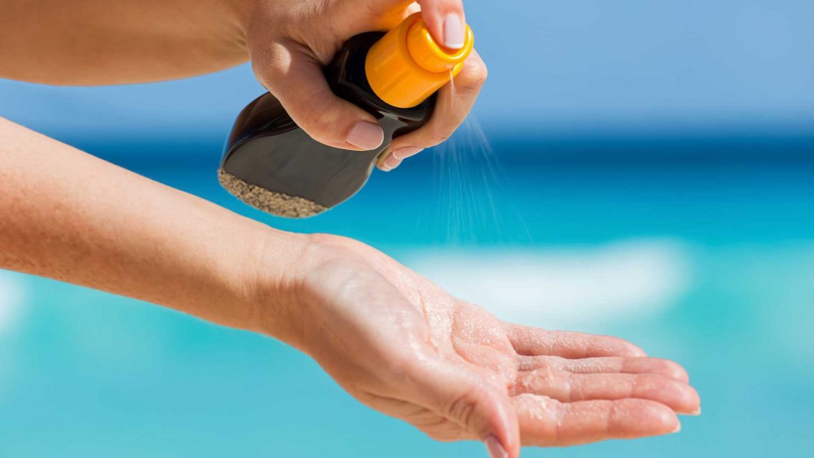 Woman applying in sunscreen
