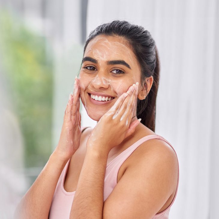 Woman cleansing her face