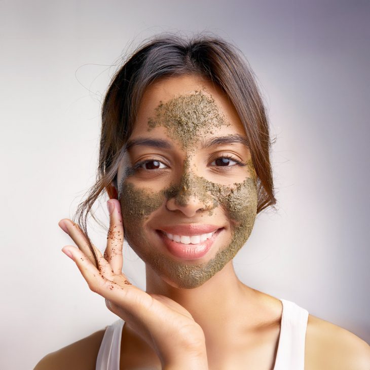 Woman exfoliating her face