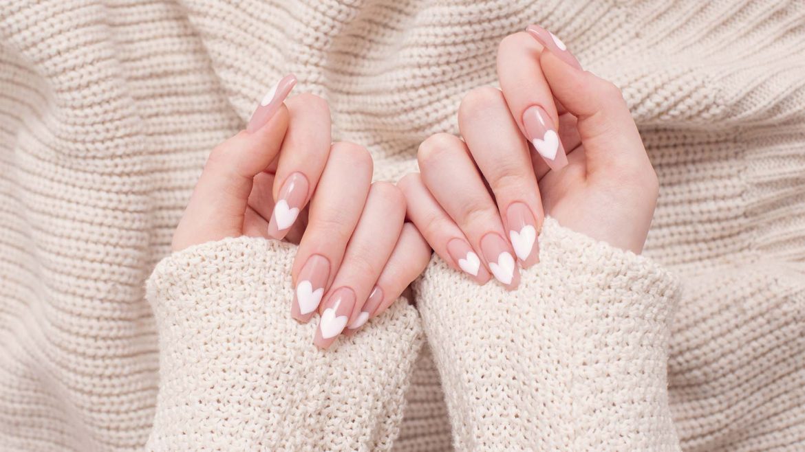  Woman with French manicure with heart-shaped art