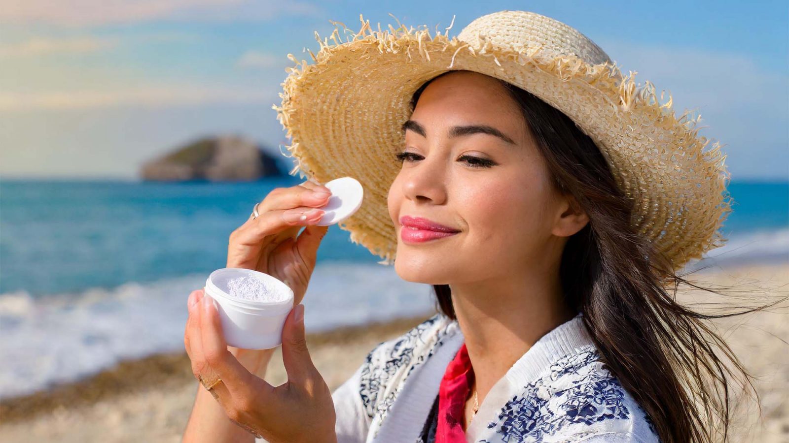 Woman applying powder sunscreen