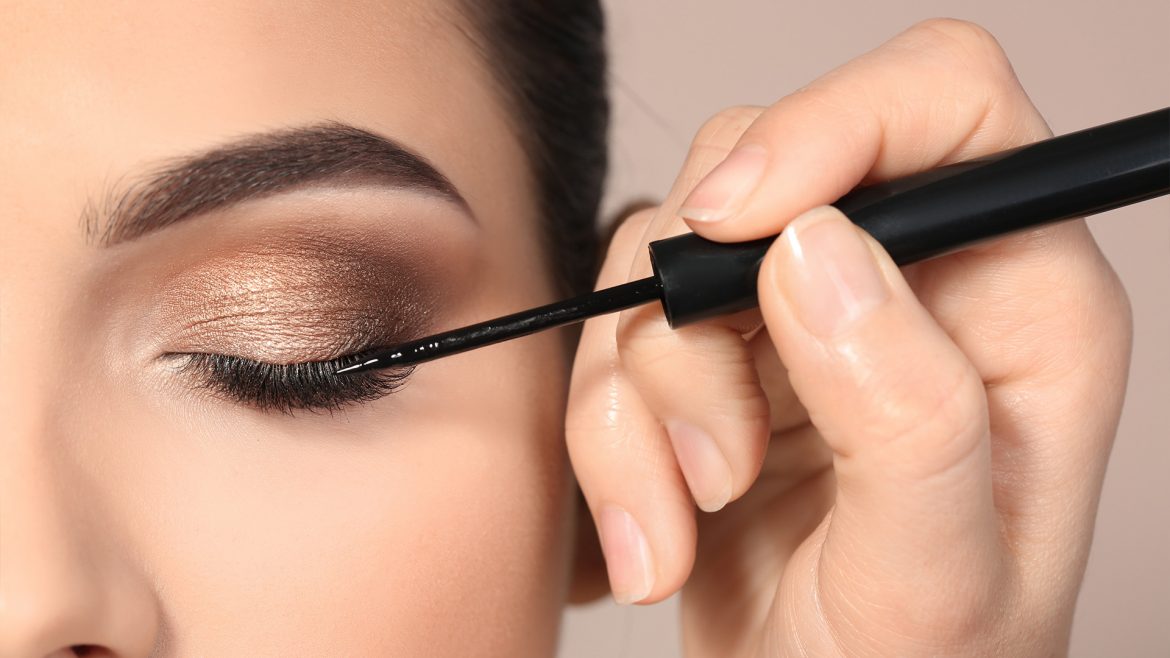 Woman applying eyeliner