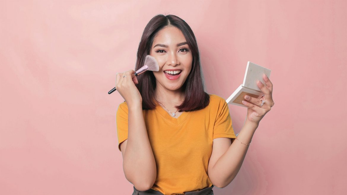 Woman applying makeup