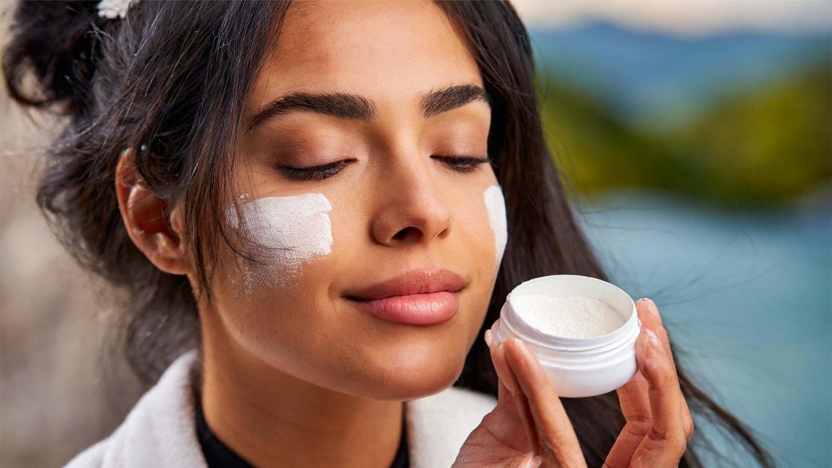 Woman applying powder sunscreen