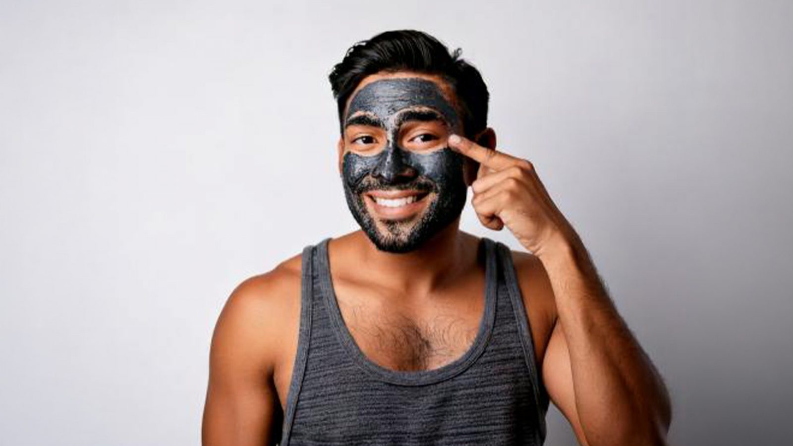 Man with charcoal face mask on his face