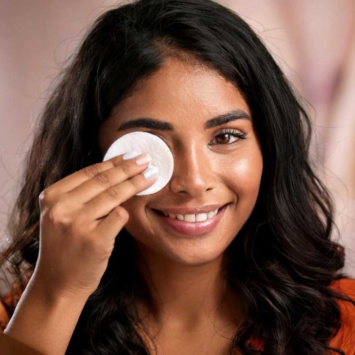 Woman wiping makeup off her eyes